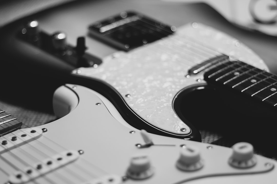 black and white photo of two stratocaster electric guitars